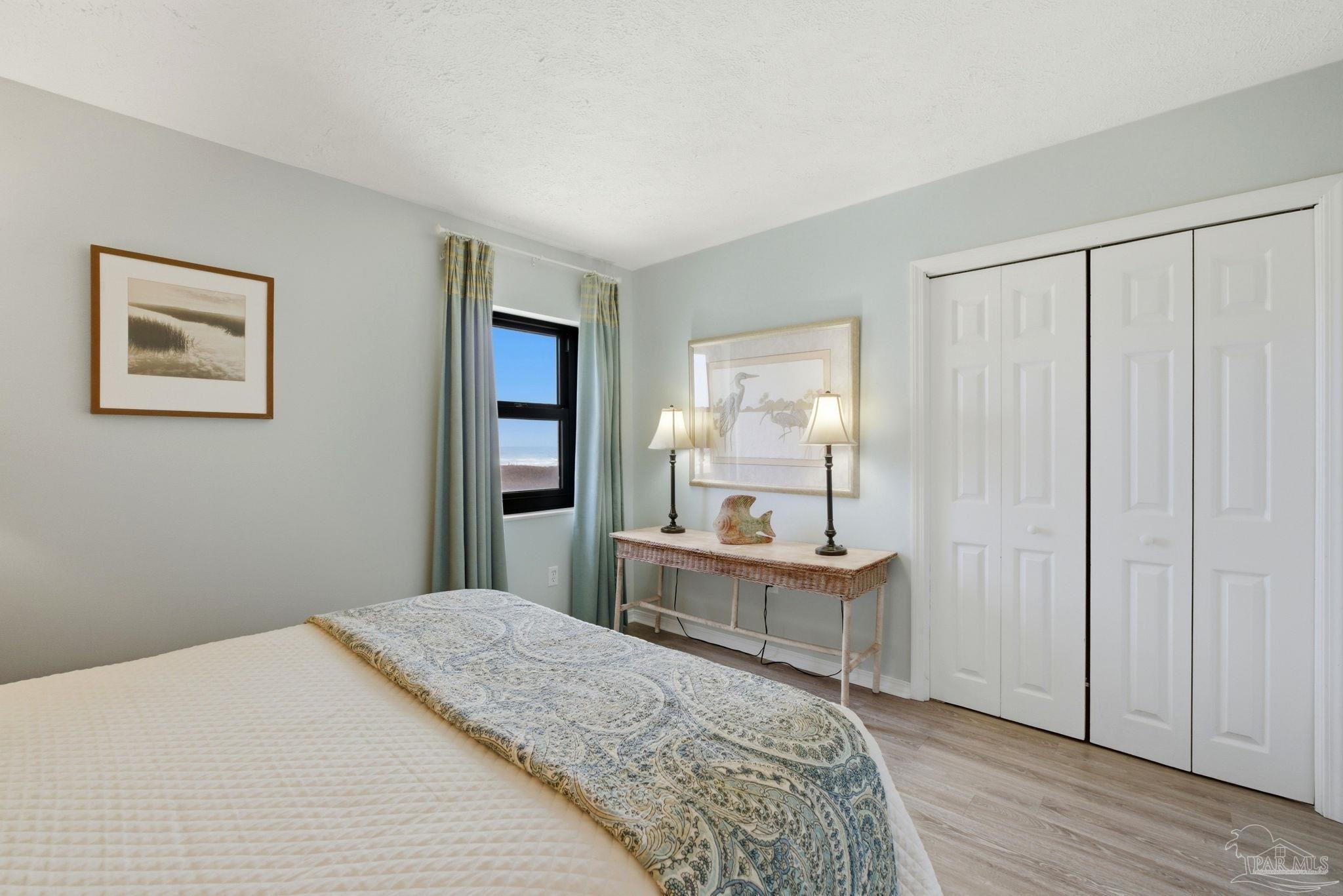 14623 Perdido Key Drive, Unit W201 Perdido Key, FL 32507 - Photo 32 of 57 a bedroom with a bed and wooden floor
