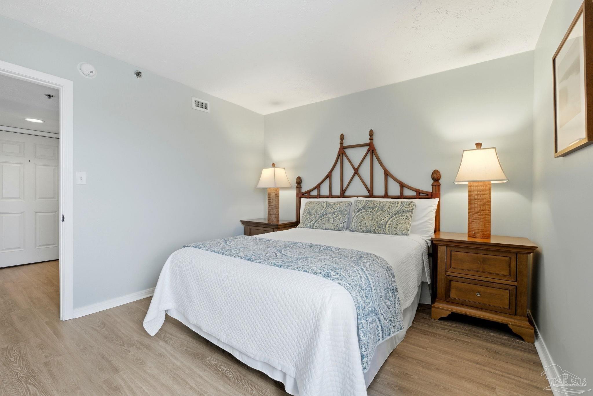 14623 Perdido Key Drive, Unit W201 Perdido Key, FL 32507 - Photo 33 of 57 a bedroom with a bed and a lamp