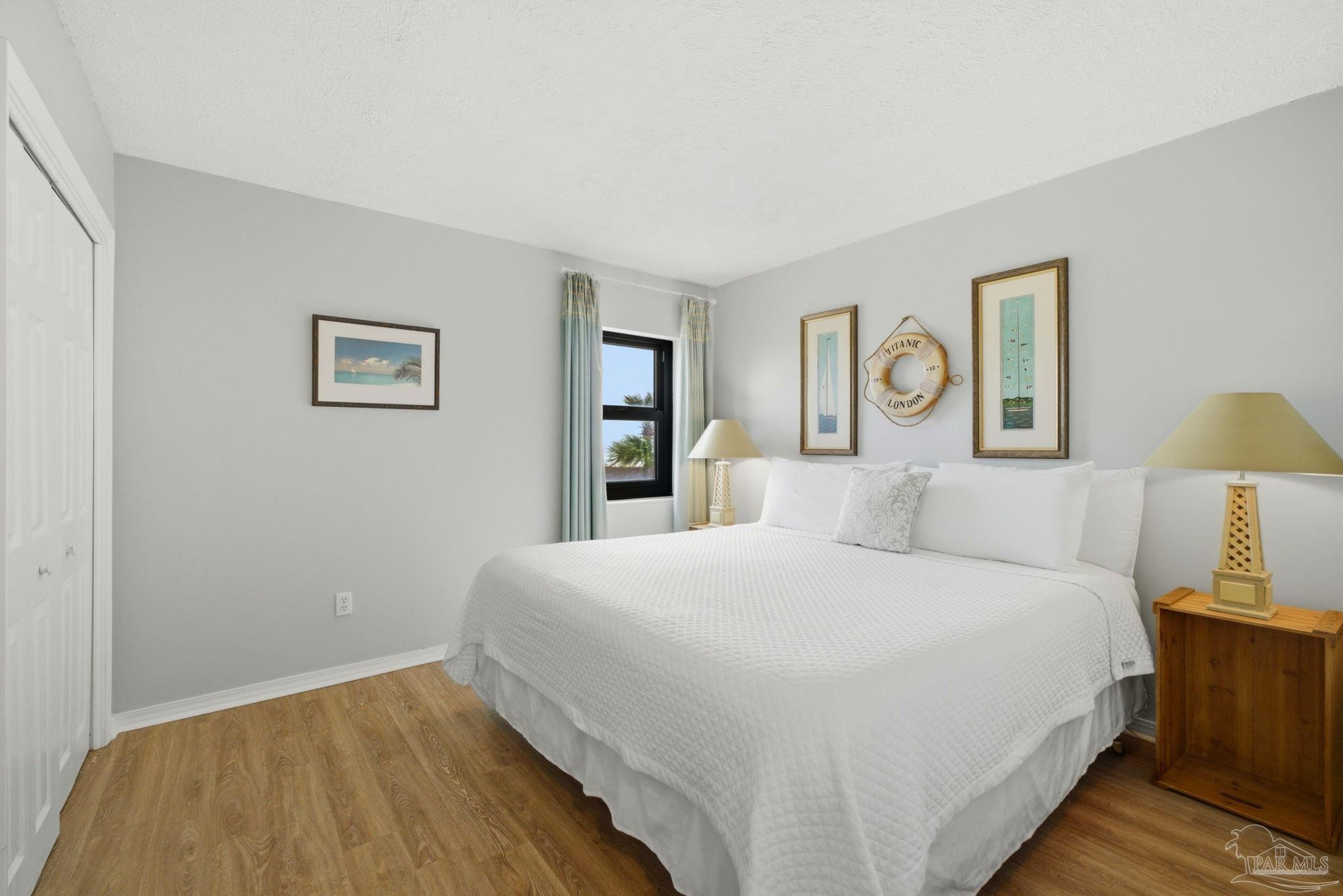 14623 Perdido Key Drive, Unit W201 Perdido Key, FL 32507 - Photo 34 of 57 a bedroom with a bed and painting on the wall