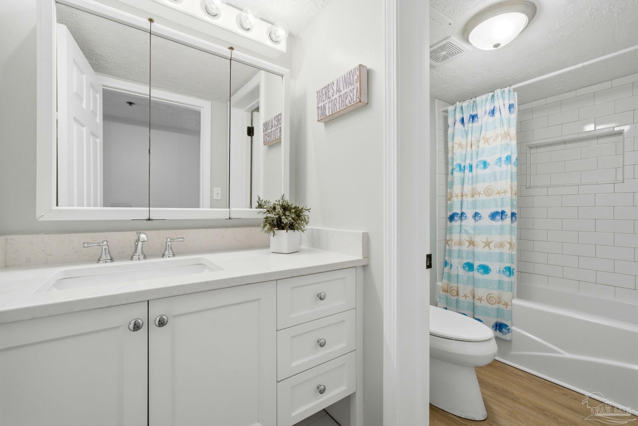 14623 Perdido Key Drive, Unit W201 Perdido Key, FL 32507 - Photo 36 of 57 a bathroom with a granite countertop sink toilet a shower and a mirror