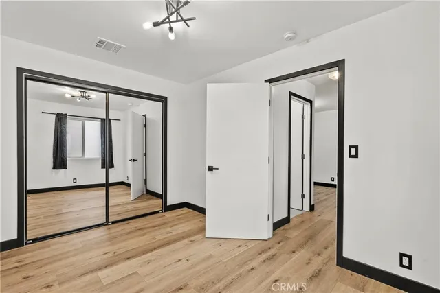 a view of a livingroom with wooden floor and a ceiling fan