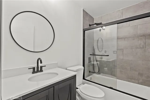 a bathroom with a sink toilet and a mirror