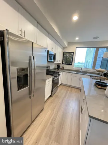 a kitchen with stainless steel appliances a refrigerator and a stove