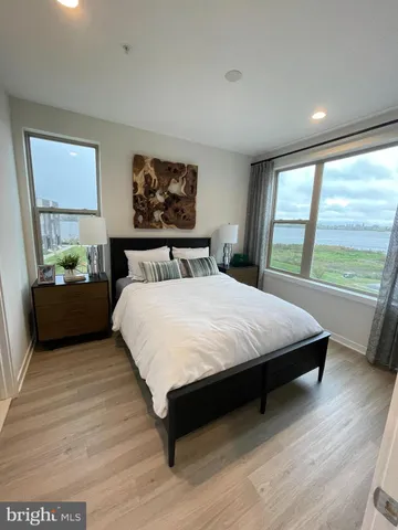 a bedroom with a large bed and a large window