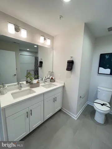 a bathroom with a double vanity sink and mirror