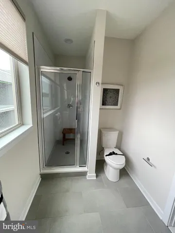 a bathroom with a toilet and a shower