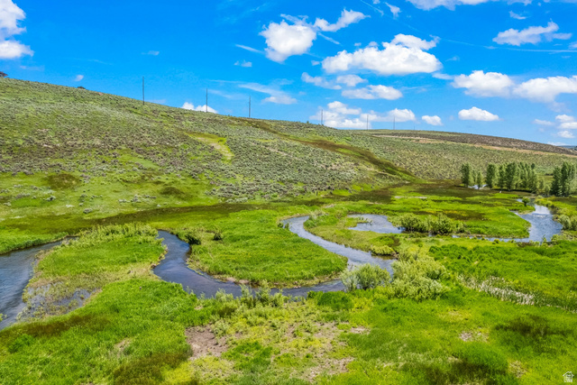 900 Bitner Road, Unit K25 Park City, UT 84098 - Photo 5 of 35 Natural landscape with a winding river, verdant grasslands, and distant hills