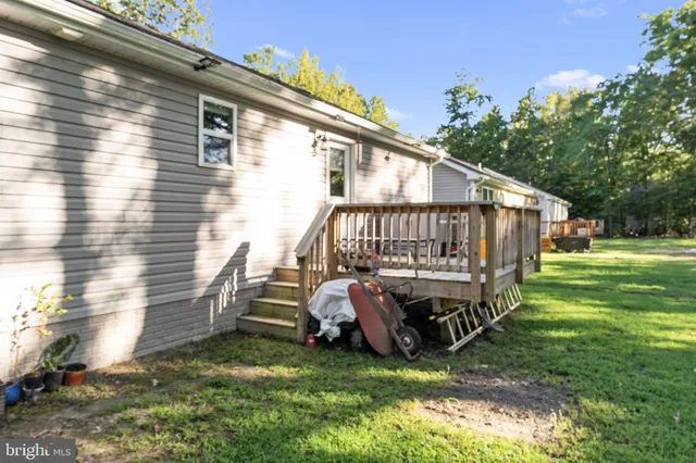 a view of backyard with deck and seating area