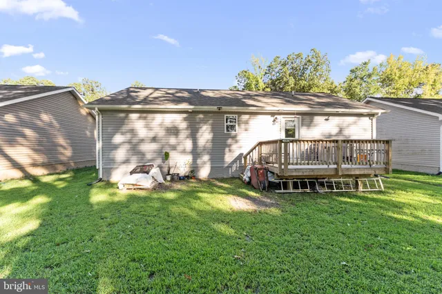 a view of a house with a yard and sitting area