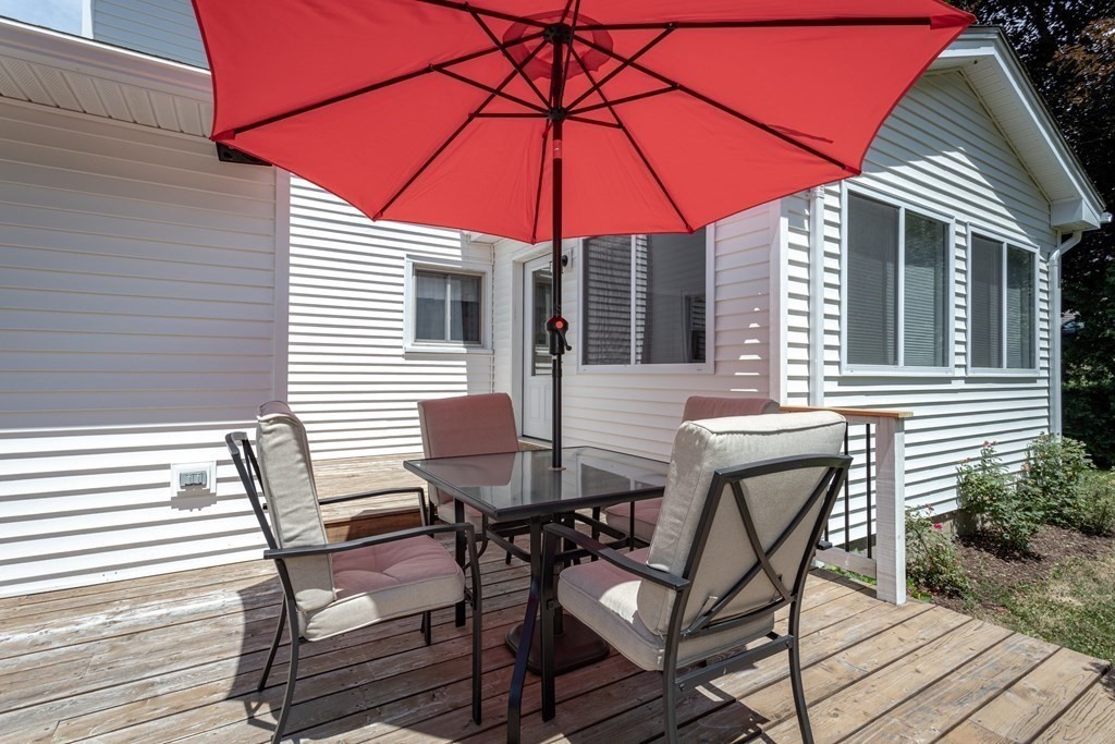104 Gilbert Road Southampton, MA 01073 - Photo 34 of 42 a patio with a table and chairs under an umbrella