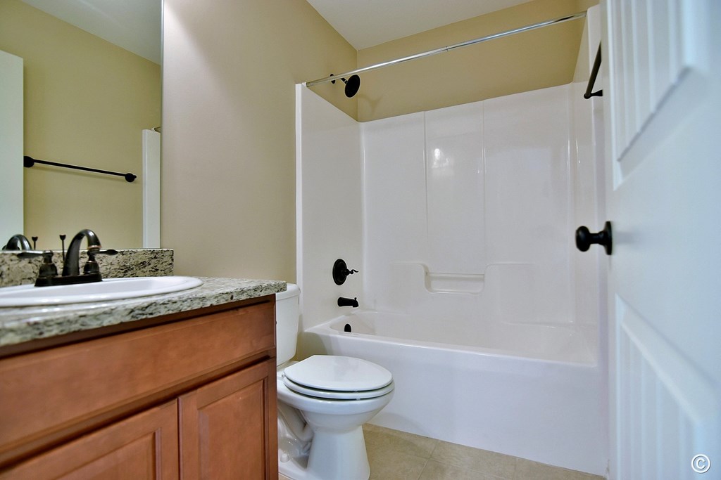 9533 Yarbrough Road Midland, GA 31820 - Photo 18 of 29 a bathroom with a granite countertop sink toilet and shower