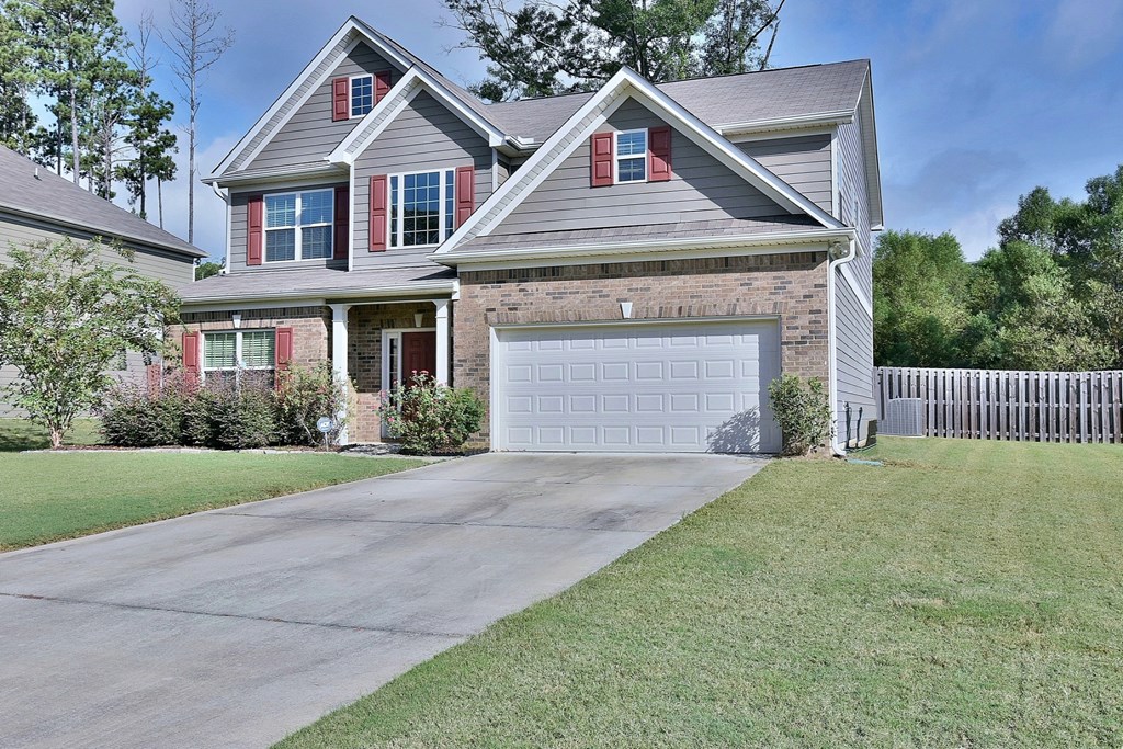 9533 Yarbrough Road Midland, GA 31820 - Photo 2 of 29 a front view of a house with a yard and garage