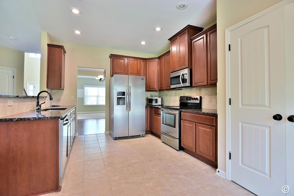 9533 Yarbrough Road Midland, GA 31820 - Photo 9 of 29 a kitchen with stainless steel appliances granite countertop a refrigerator stove top oven and sink