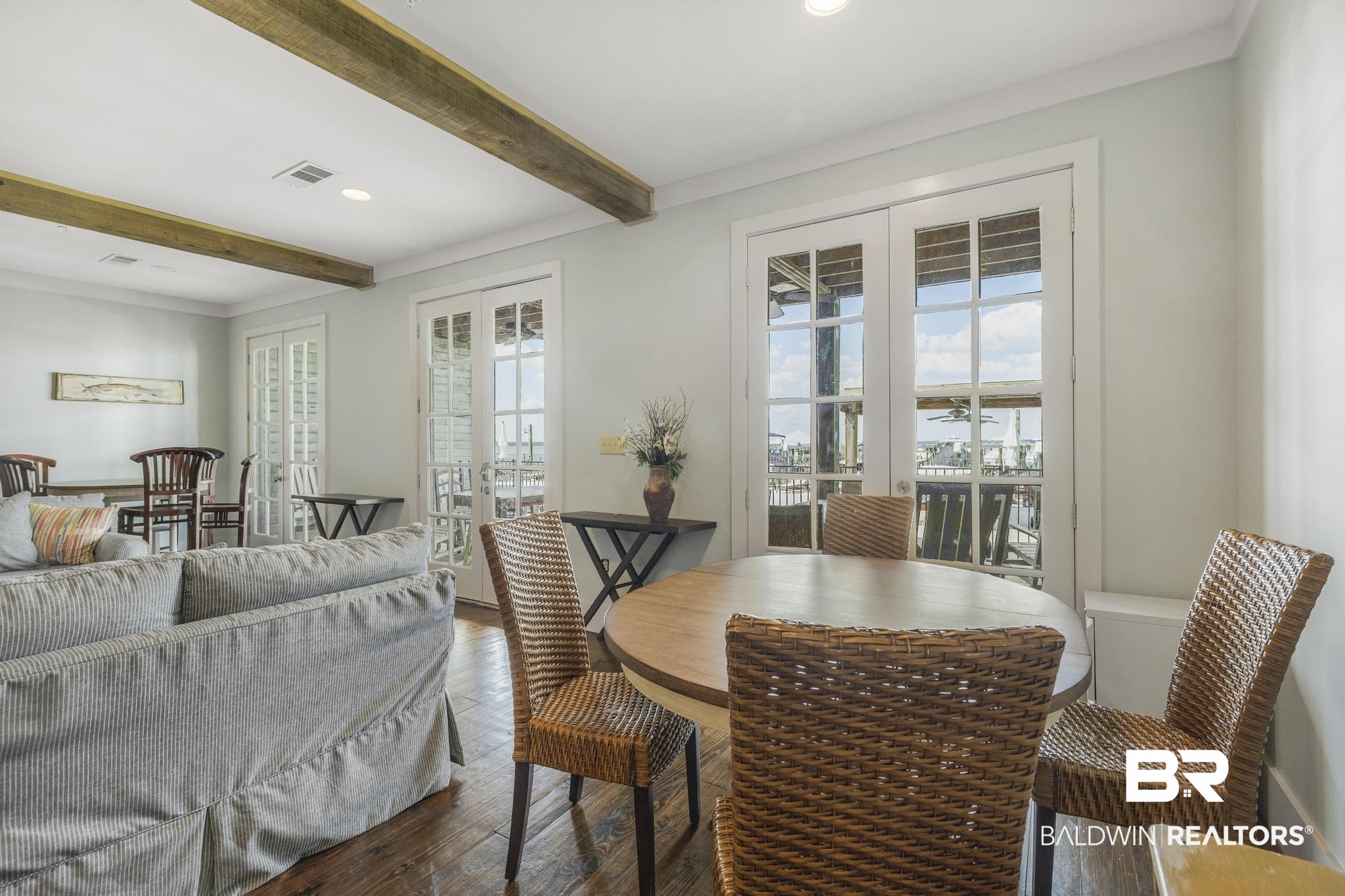 25773 Canal Road Orange Beach, AL 36561 - Photo 29 of 32 Dining room with wood-type flooring, beamed ceiling, french doors, and recessed lighting