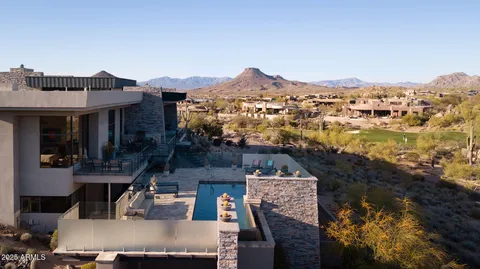 an aerial view of residential houses with outdoor space and seating