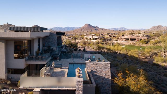 an aerial view of residential houses with outdoor space and seating