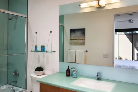 a bedroom with a bed and a mirror