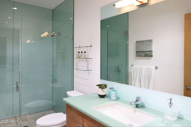 a bedroom with a bed and painting on the wall