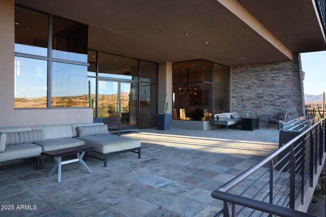 a living room with fireplace furniture and a large window