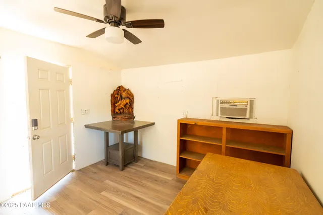 a view of a white house with wooden walls and floor to ceiling window