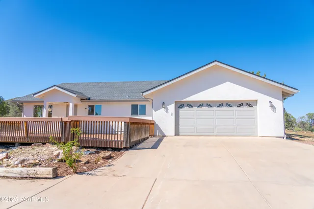 a view of a dry yard with wooden fence