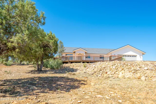 a hallway with wooden floor windows and a kitchen view
