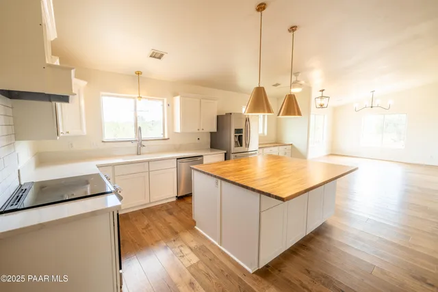 a kitchen with granite countertop a sink and a stove top oven