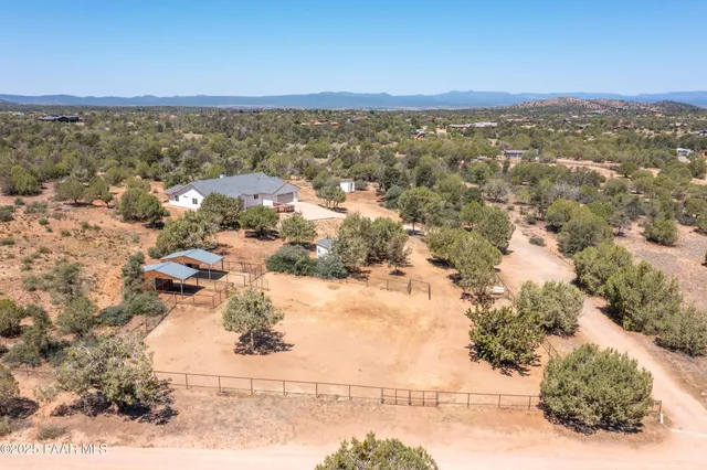 a view of a house with wooden fence