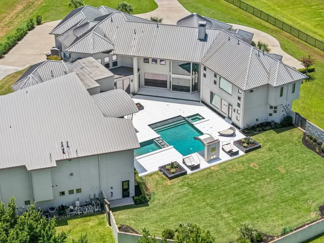 an aerial view of a house with garden space and balcony