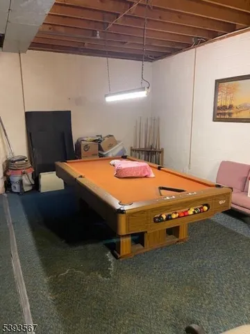 a room with furniture and pool table