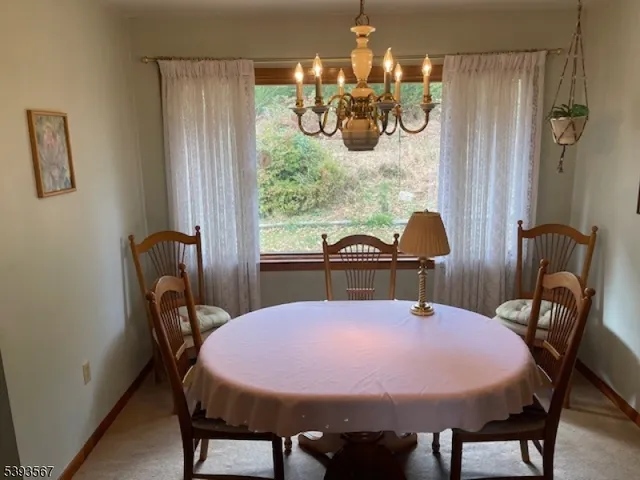 a view of a dining room with furniture and chandelier
