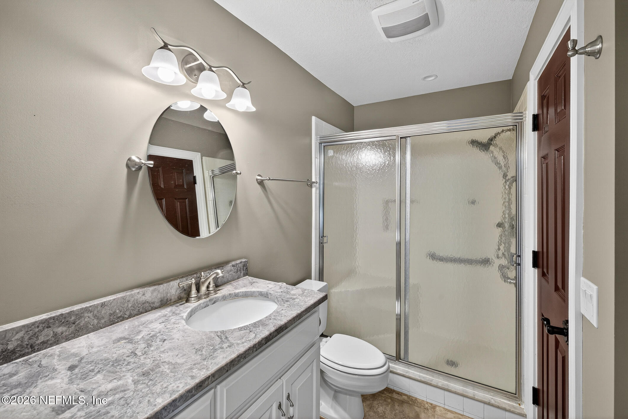 3301 Sea Marsh Road Fernandina Beach, FL 32034 - Photo 28 of 41 a bathroom with a granite countertop sink a toilet and a mirror