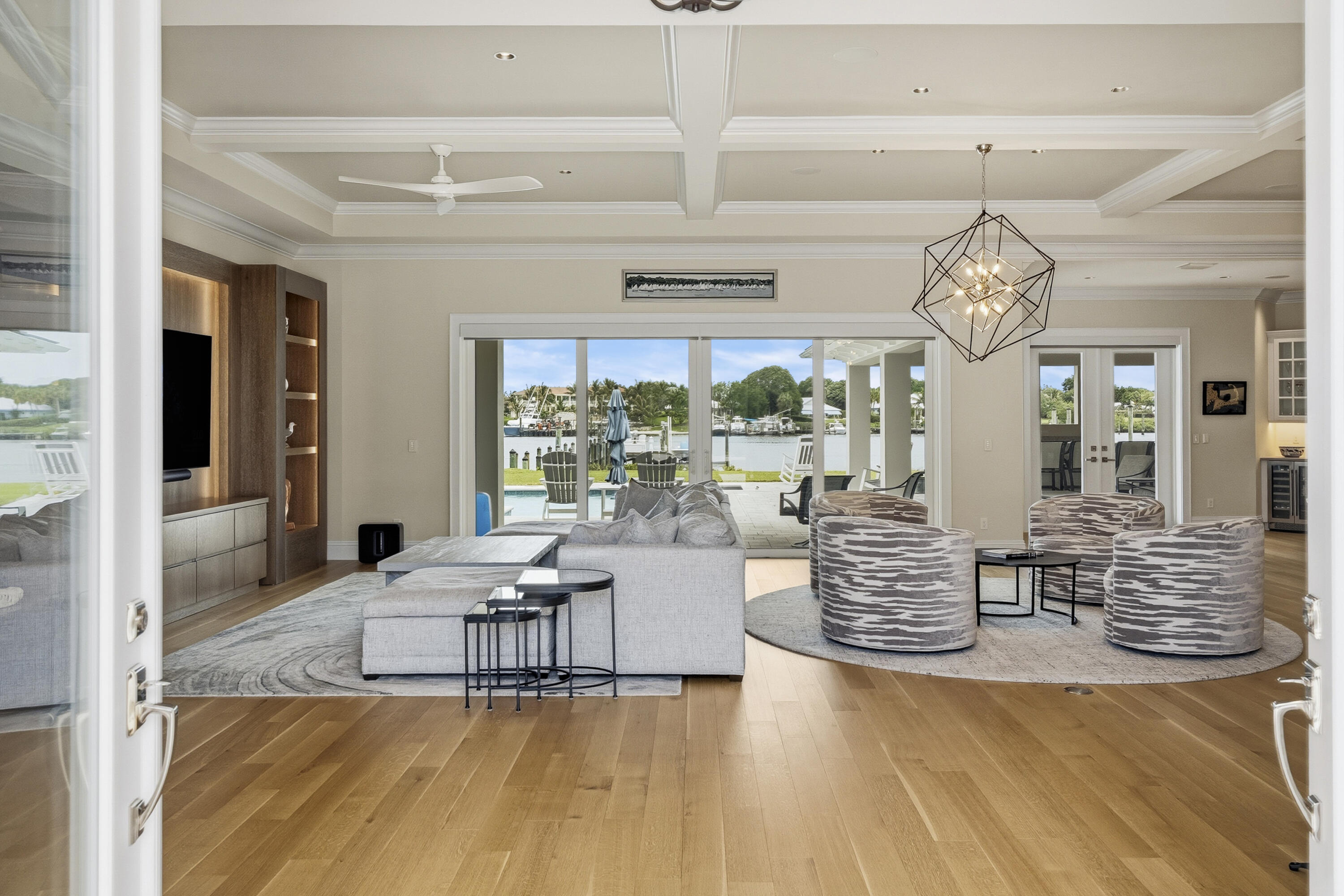 3973 Southeast Topsail Court Stuart, FL 34997 - Photo 4 of 38 a living room with fireplace furniture and a chandelier