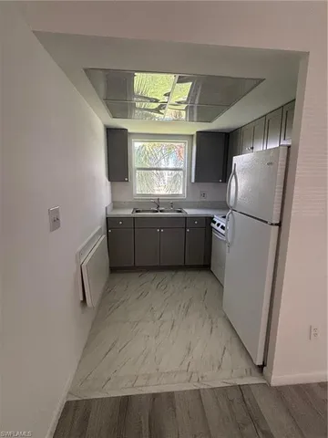 a kitchen with stainless steel appliances granite countertop a refrigerator and a sink