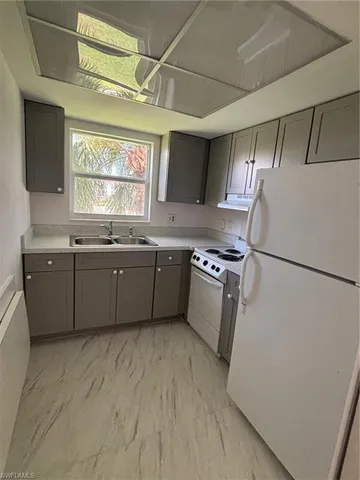 a kitchen with stainless steel appliances a sink stove and refrigerator