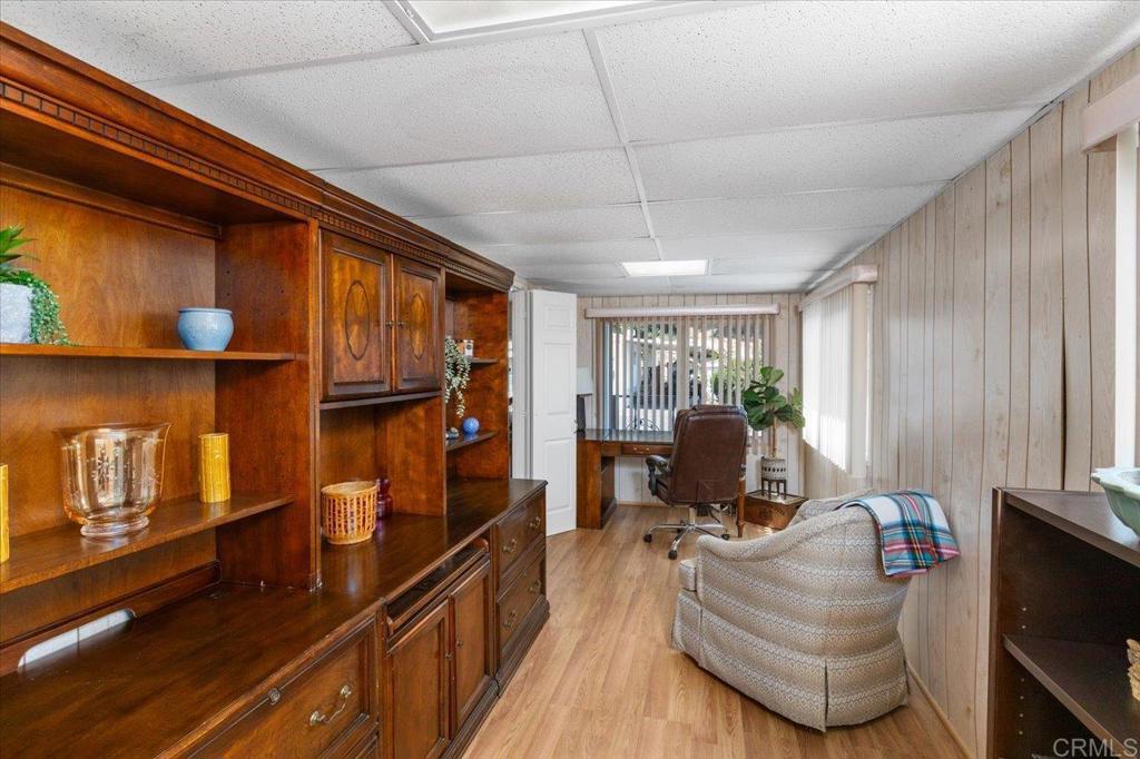 28890 Lilac Road, Unit 80 Valley Center, CA 92082 - Photo 20 of 33 a living room with furniture a flat screen tv and gym equipment
