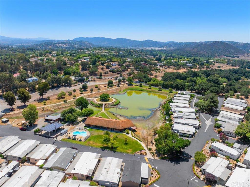 28890 Lilac Road, Unit 80 Valley Center, CA 92082 - Photo 31 of 33 an aerial view of a city with lots of residential buildings and mountain view in back