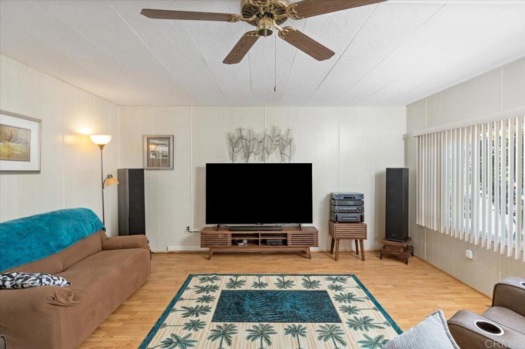 28890 Lilac Road, Unit 80 Valley Center, CA 92082 - Photo 4 of 33 a room with furniture and a flat screen tv