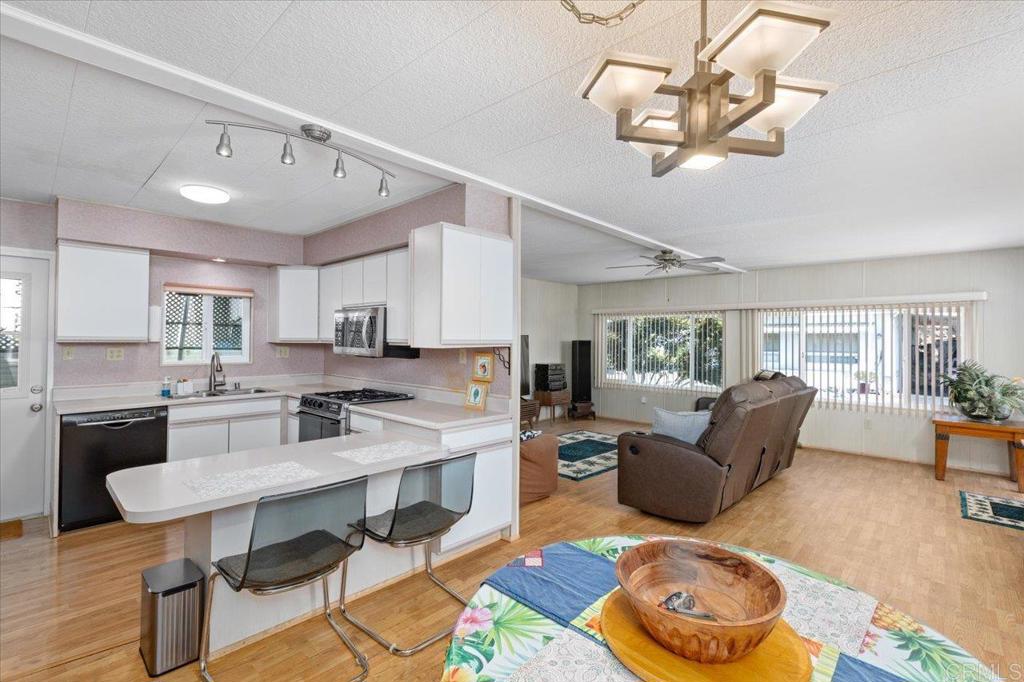 28890 Lilac Road, Unit 80 Valley Center, CA 92082 - Photo 6 of 33 a living room with furniture and kitchen view