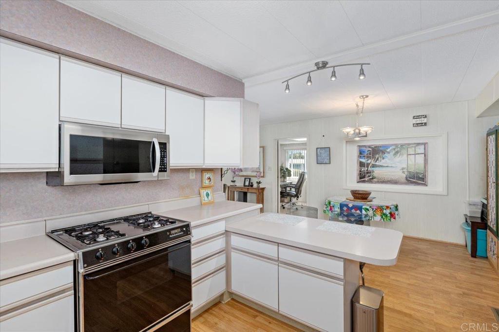 28890 Lilac Road, Unit 80 Valley Center, CA 92082 - Photo 10 of 33 a kitchen with a stove and a microwave