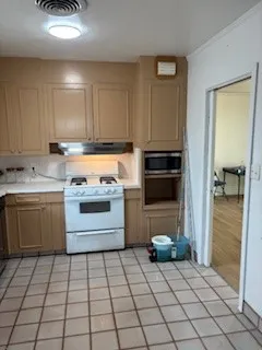 a kitchen with a stove a sink and a refrigerator