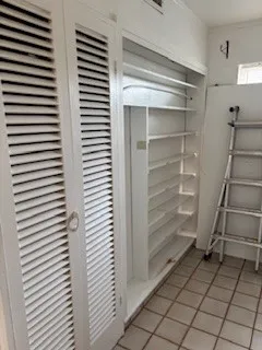 a view of walk in closet with empty racks