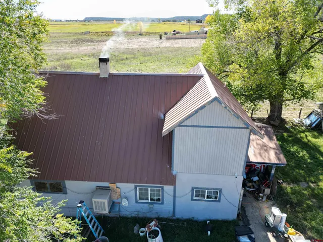 an aerial view of a house with a yard and lake view
