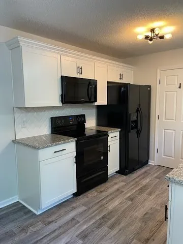 a kitchen with a refrigerator stove and microwave