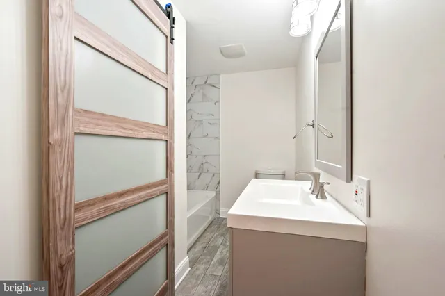 a bathroom with a sink and mirror