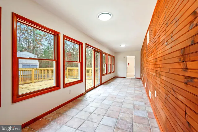 a view of deck with wooden floor and fence next to a yard