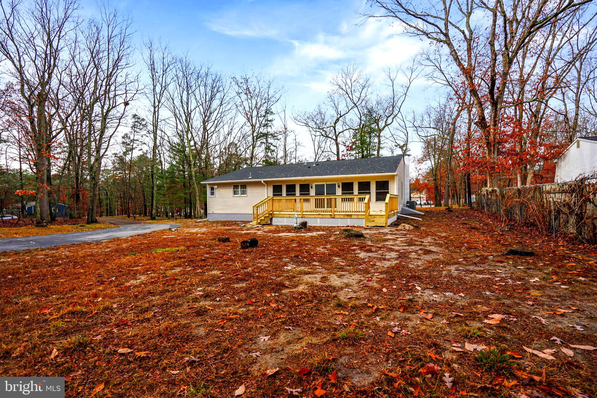 52 Summit Drive Tabernacle, NJ 08088 - Photo 27 of 27 a backyard of a house with large trees and outdoor seating