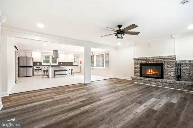 a view of an empty room with a fireplace and a window