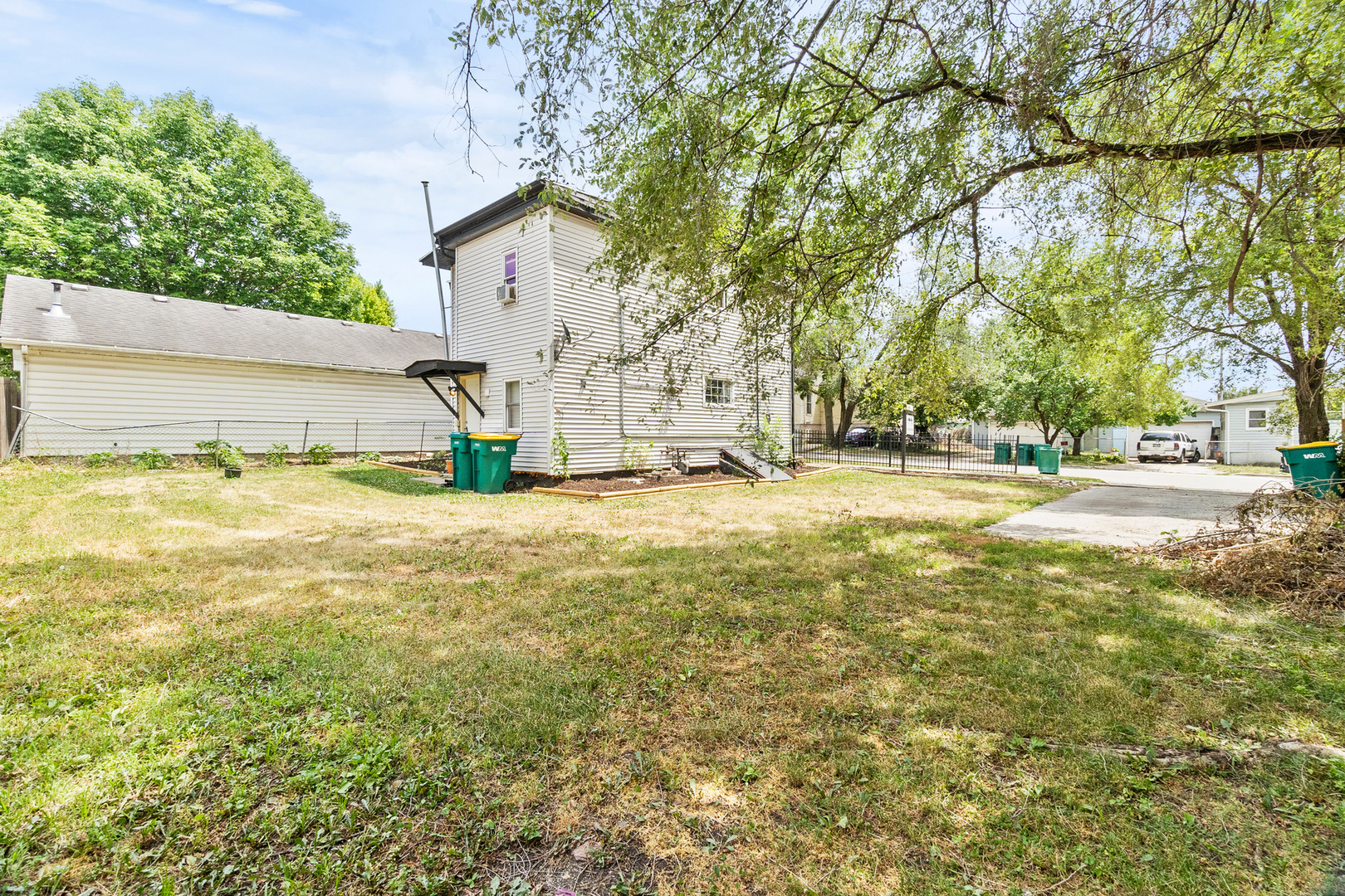 305 Irving Street Joliet, IL 60432 - Photo 2 of 20 a view of a yard with yellow house