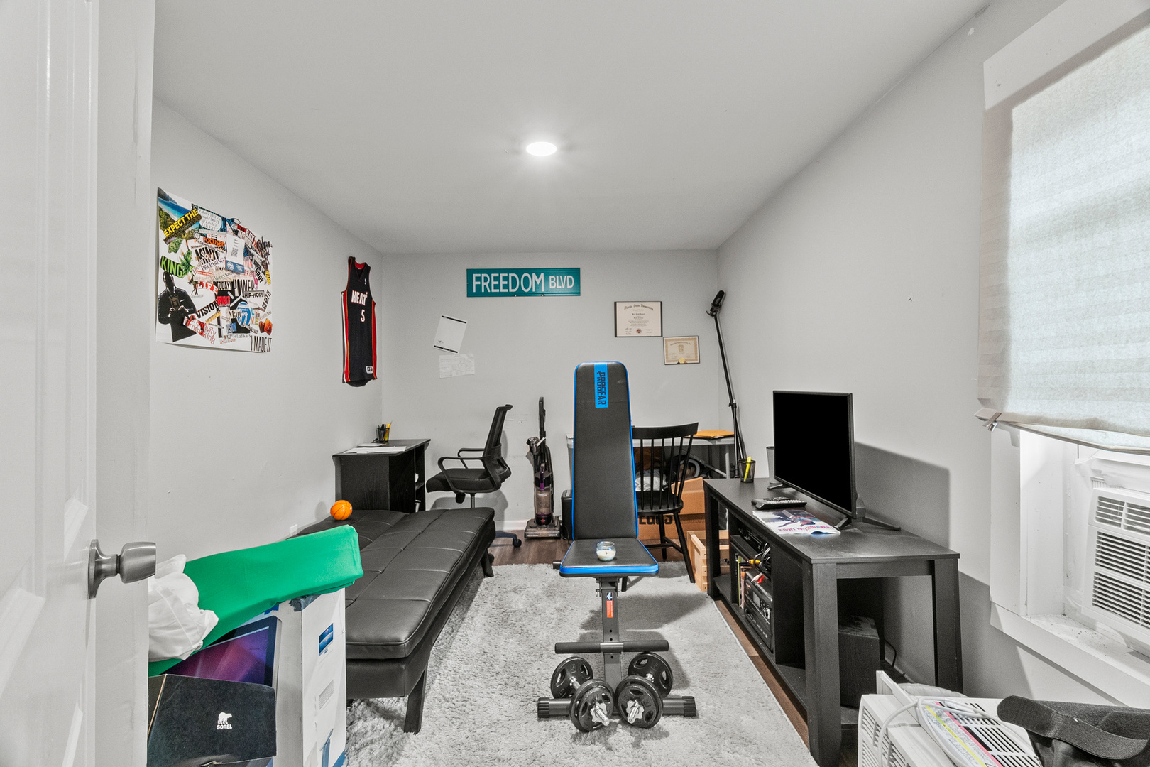 305 Irving Street Joliet, IL 60432 - Photo 4 of 20 a view of a workspace with furniture and a flat screen tv